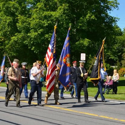 VFW Post 7765 color guard marching in a parade with American and post flags