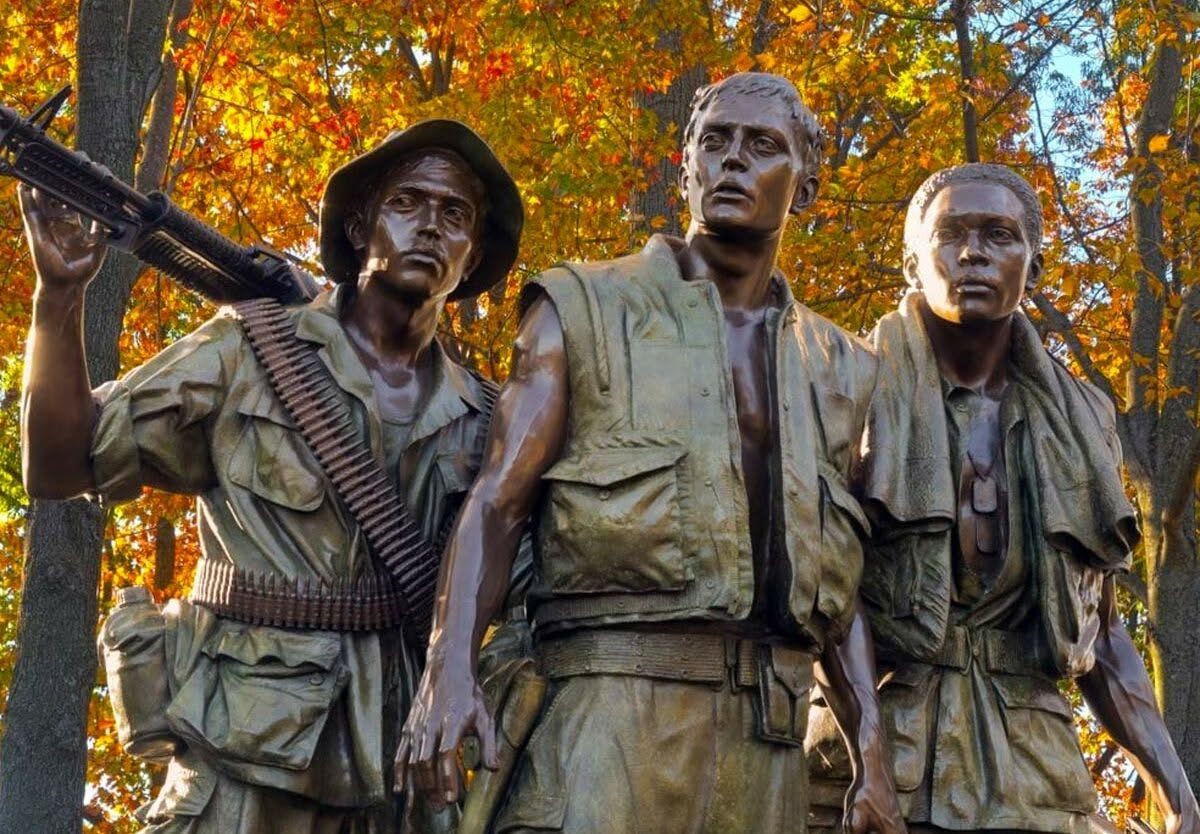 The Three Soldiers bronze statue at the Vietnam Veterans Memorial in autumn